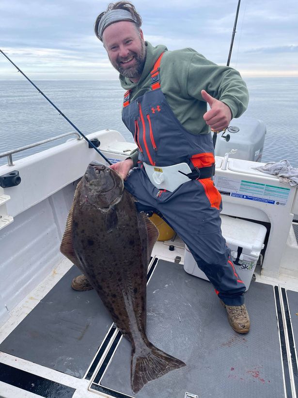 Burstwick fisherman Shaun Porter proudly shows off his 50lb halibut caught off Whitby