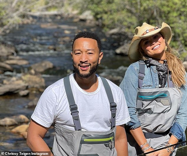 At one with nature: John and Chrissy smiled for the camera as they enjoyed the fresh country air on Tuesday