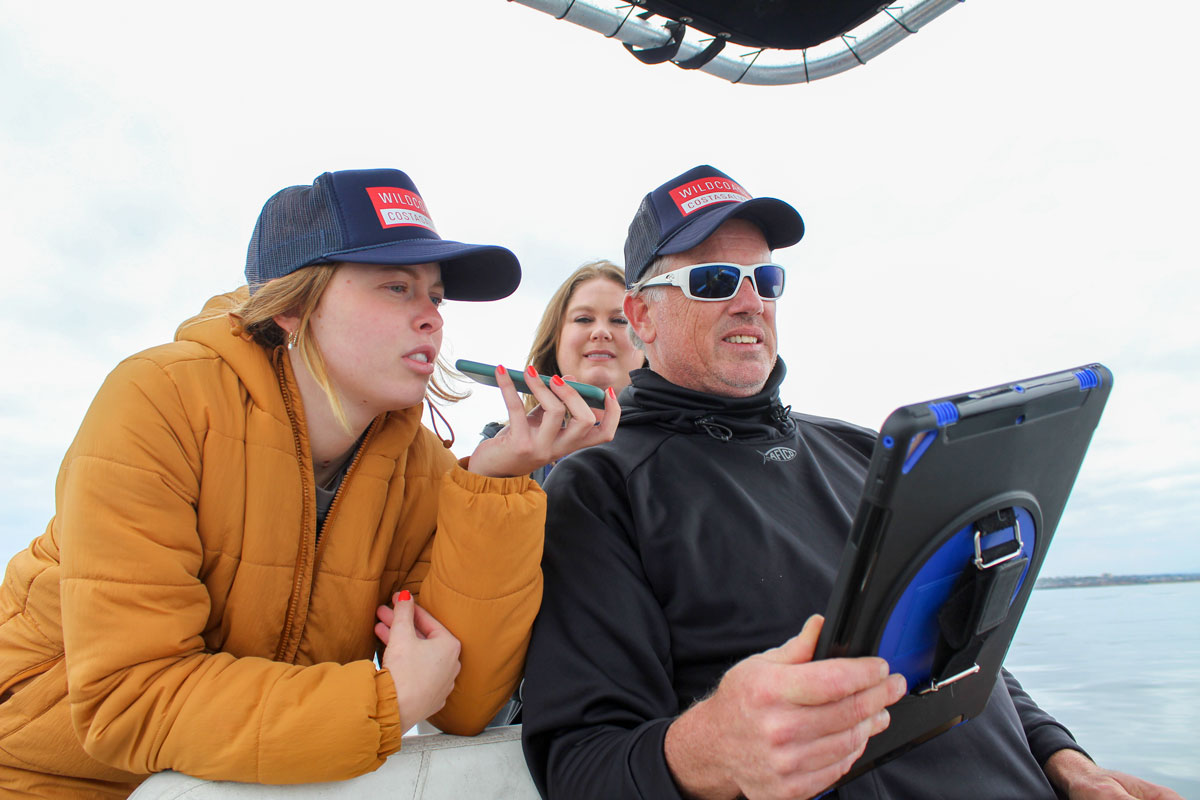 Wildcoast's Lillie Mulligan, left, Angela Kemsley, center, and Joe Cooper verify the coordinates of a potential poacher to CalTIPS after it was picked up by Cooper's state-of-the-art radar system. Photo by Jordan P. Ingram