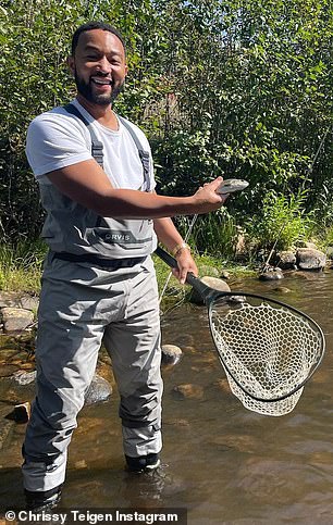He's got one: Legend, 42, looked delighted as he showed off his meagre catch - a small fish triumphantly held in his right hand