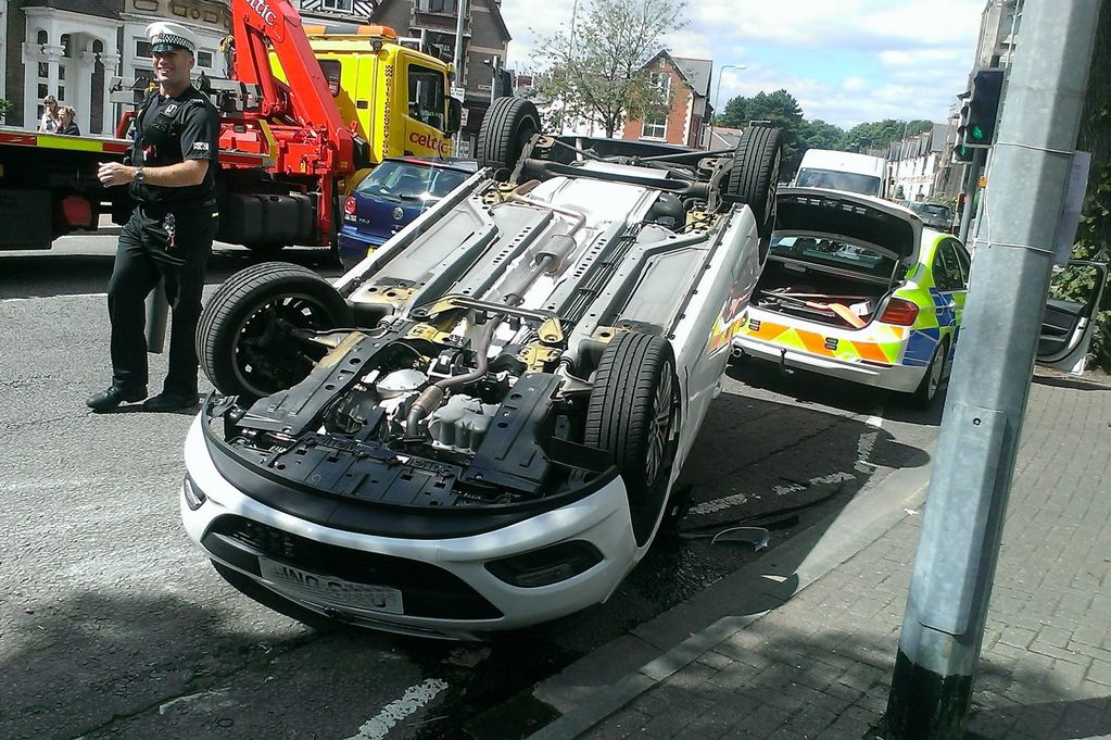 Woman arrested on suspicion of drink driving after car flips on its ...
